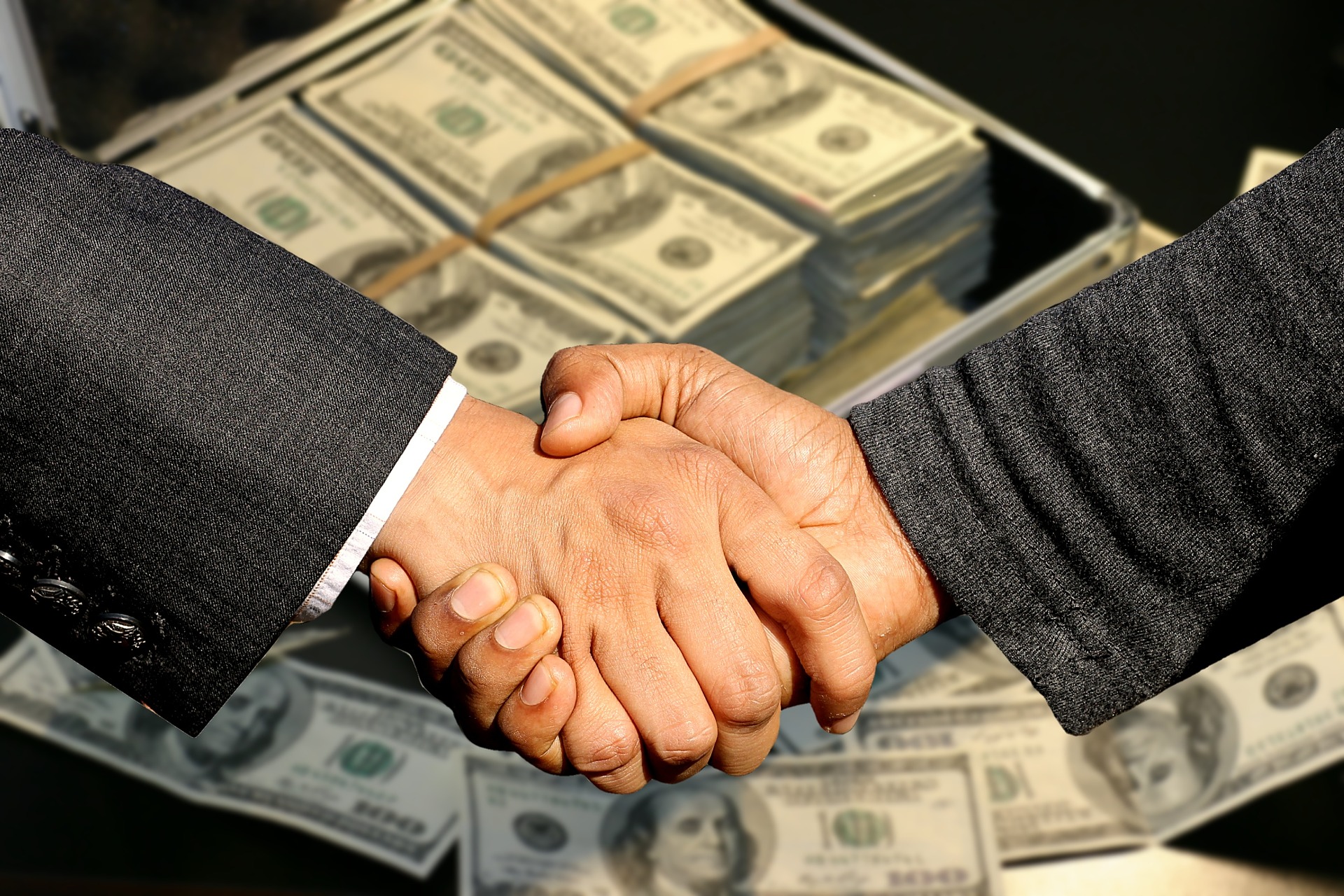 Sell a business - handshake-buyer-seller